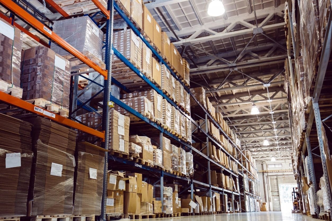 A warehouse filled with lots of boxes and shelves.