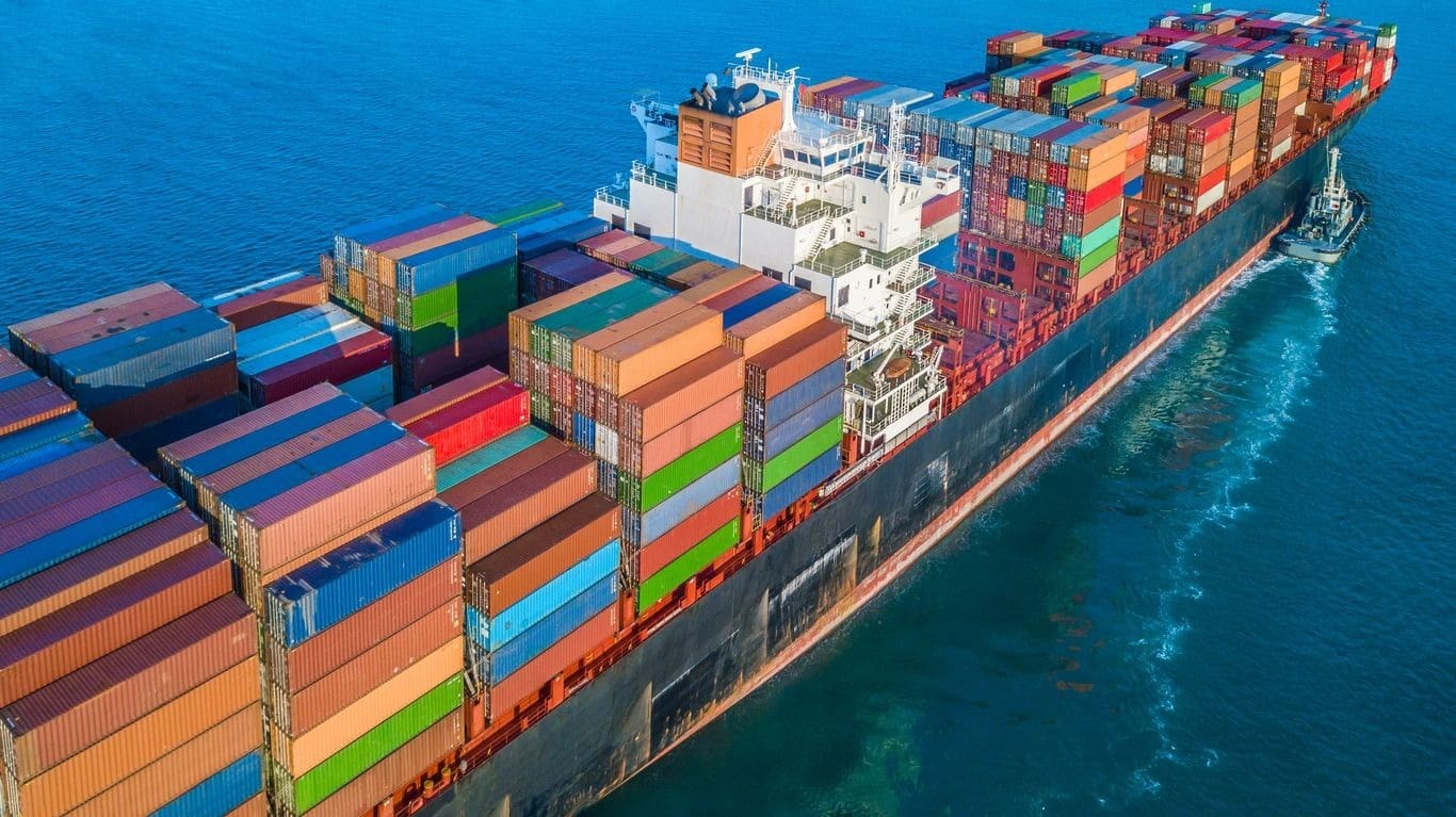 A large cargo ship with many containers on it.