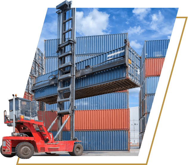 A forklift is parked in front of a large stack of containers.